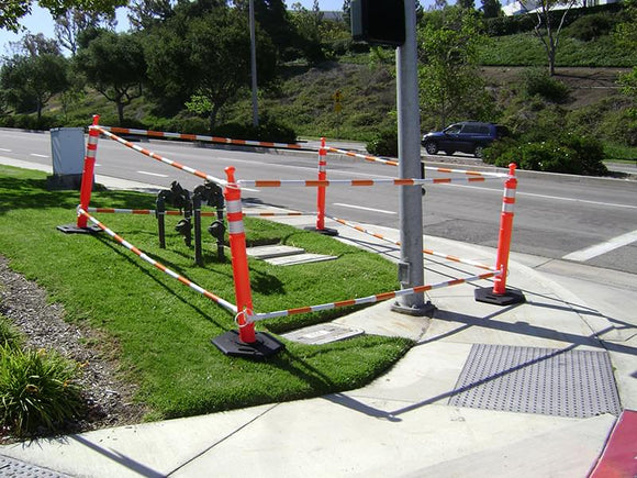 5.5' - 10.5' Orange and White Cone Bars (#150610A-CBOW) with 4x Grabber-Tube II's cordoning off a work zone.