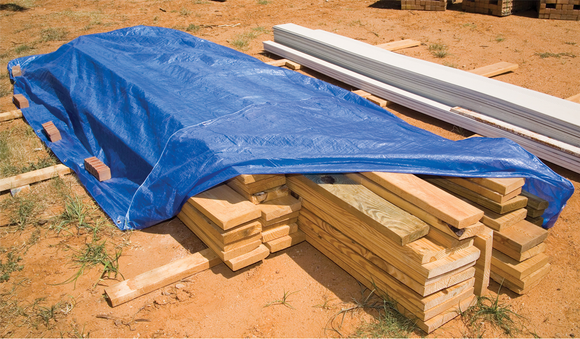 Blue economy tarp covering lumber; representative application, not a size illustration